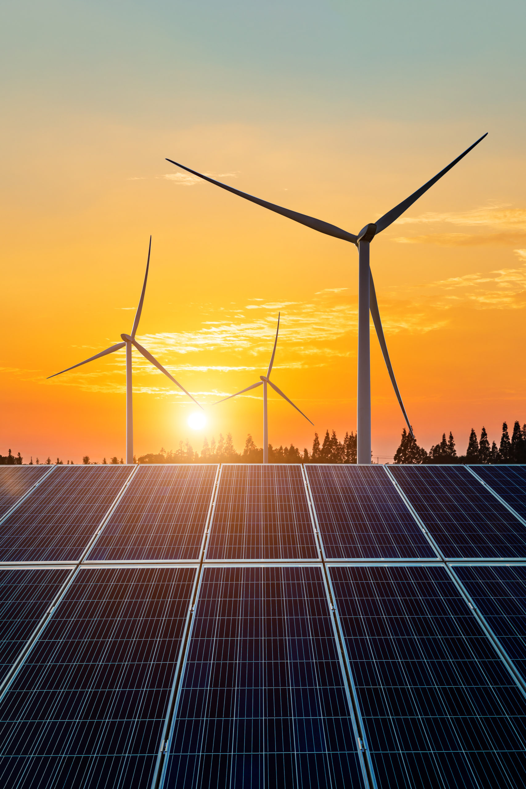 Wind turbines and solar panels at sunset. renewable energy concept.